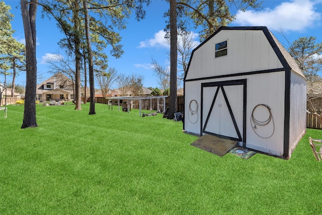 view of yard with an outbuilding, fence, and a shed