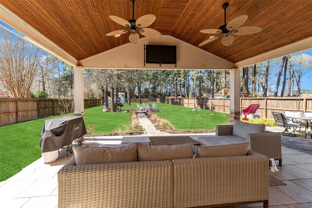 view of patio / terrace featuring ceiling fan, a fenced backyard, a grill, and an outdoor living space