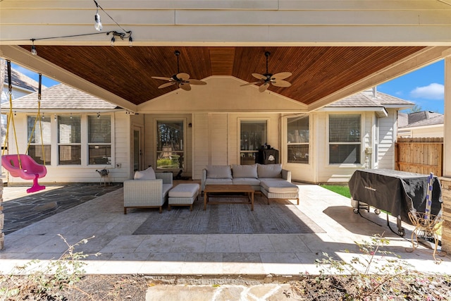 view of patio / terrace featuring fence, an outdoor living space, and ceiling fan