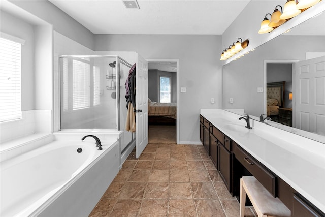 ensuite bathroom with vanity, ensuite bath, visible vents, and a shower stall