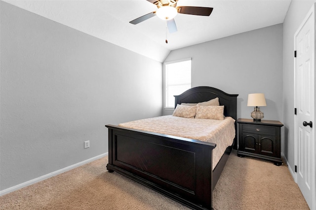 bedroom with a ceiling fan, lofted ceiling, light colored carpet, and baseboards