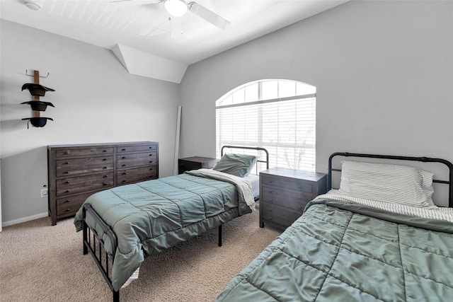 bedroom with carpet floors, vaulted ceiling, baseboards, and a ceiling fan