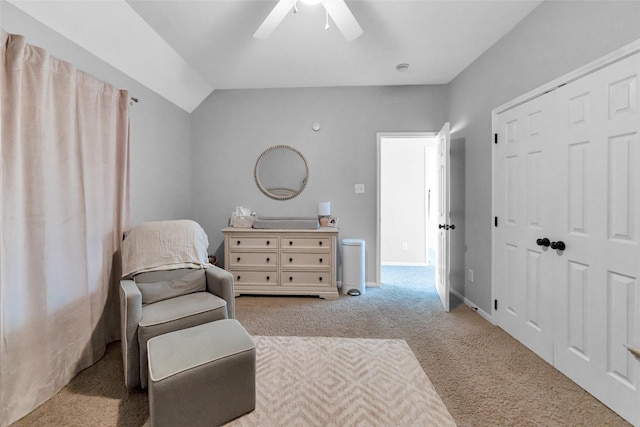 sitting room featuring carpet floors, vaulted ceiling, baseboards, and a ceiling fan