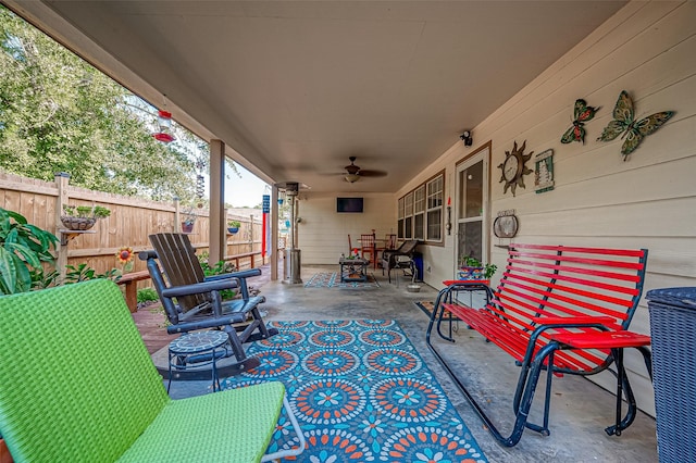 view of patio / terrace with ceiling fan, fence, and outdoor dining space