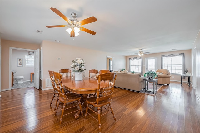 dining area featuring baseboards, visible vents, and hardwood / wood-style floors