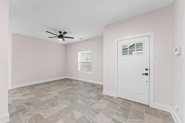 foyer featuring visible vents, baseboards, and ceiling fan