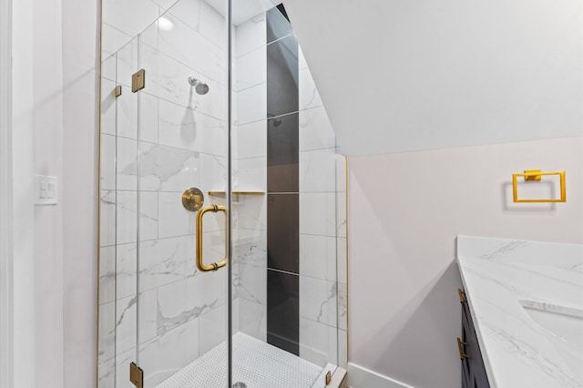 full bathroom featuring a shower stall, lofted ceiling, and a sink