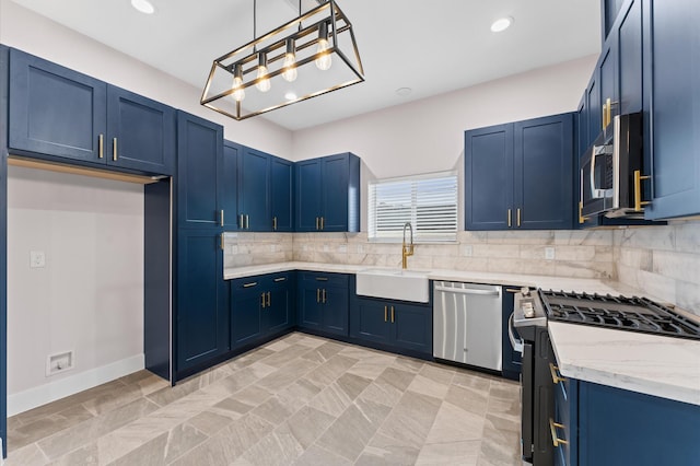 kitchen featuring decorative backsplash, blue cabinetry, appliances with stainless steel finishes, and a sink