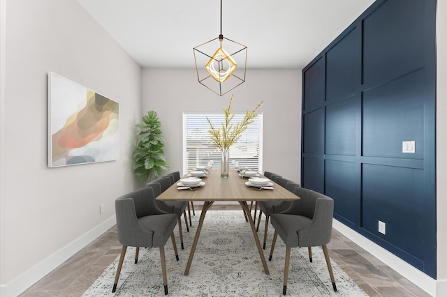 dining area with baseboards and a chandelier