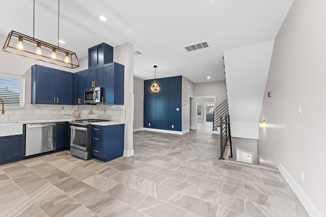 kitchen featuring tasteful backsplash, visible vents, light countertops, stainless steel appliances, and blue cabinets