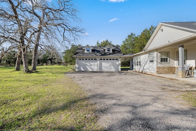 view of property exterior with a garage, aphalt driveway, and a lawn