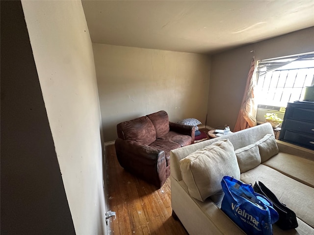 living room with cooling unit and wood finished floors