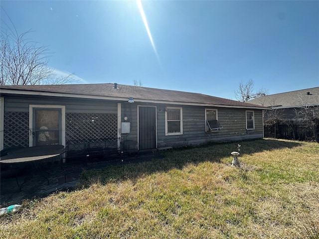 rear view of property featuring a yard