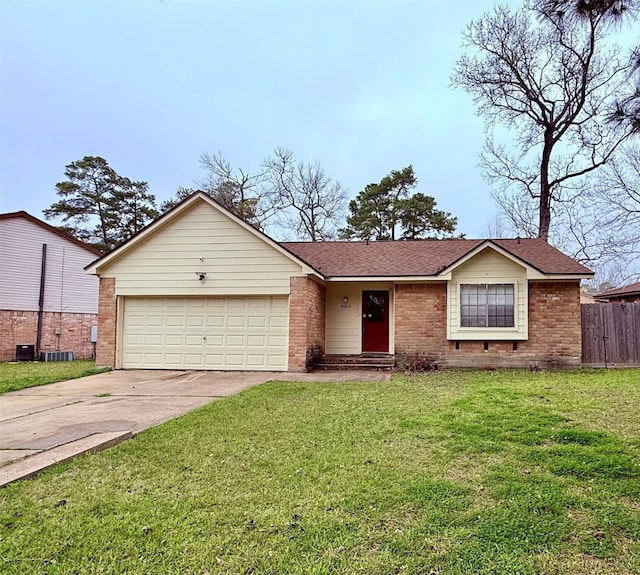 ranch-style home featuring a garage, brick siding, fence, driveway, and a front lawn