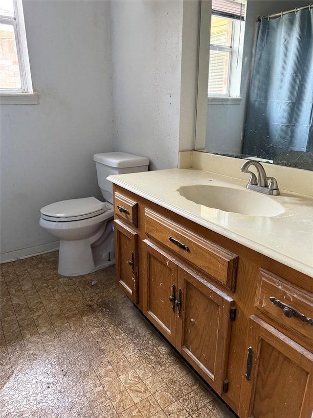 full bath featuring a shower with shower curtain, vanity, toilet, and tile patterned floors