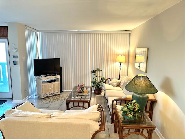 tiled living room featuring baseboards