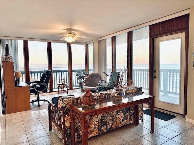 living room featuring light tile patterned floors, floor to ceiling windows, and a ceiling fan