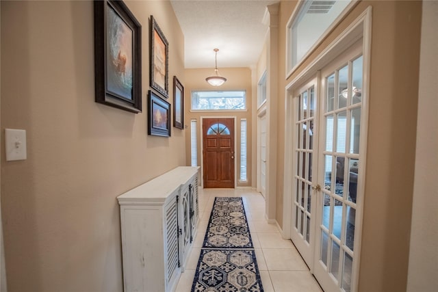 doorway featuring french doors, visible vents, and light tile patterned flooring