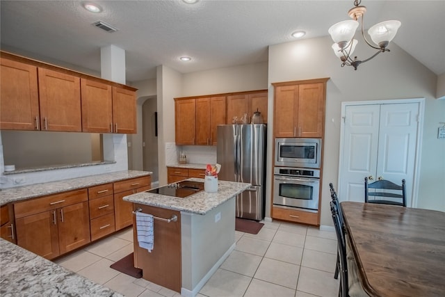 kitchen featuring light stone counters, stainless steel appliances, arched walkways, brown cabinetry, and light tile patterned floors