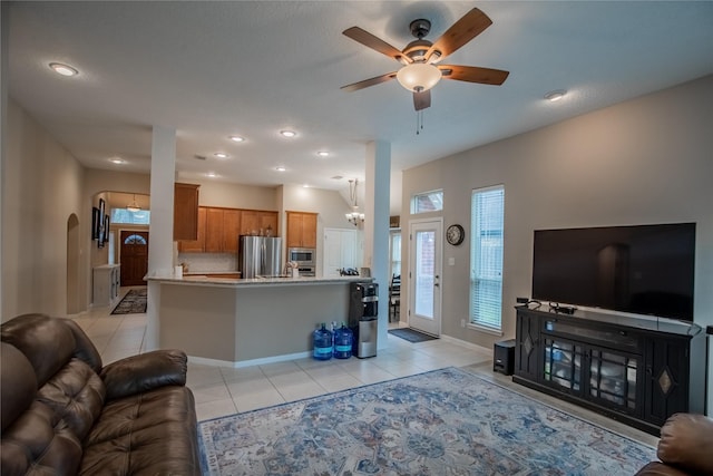 living room with light tile patterned flooring, recessed lighting, arched walkways, and ceiling fan