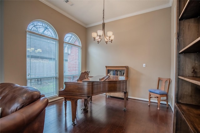 home office featuring visible vents, baseboards, ornamental molding, an inviting chandelier, and wood finished floors