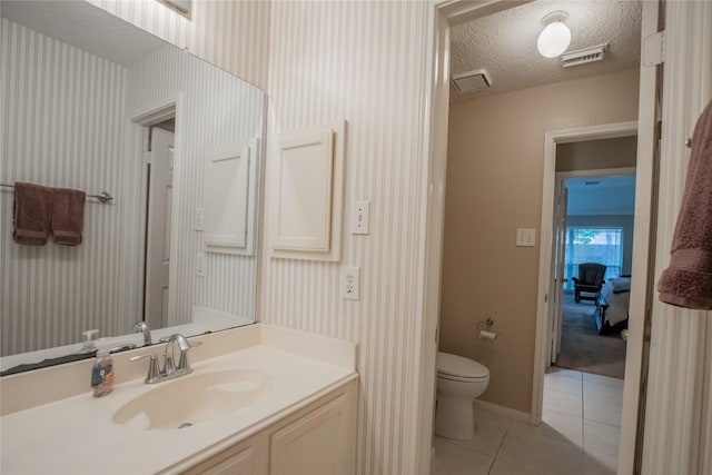 bathroom with wallpapered walls, tile patterned floors, and toilet