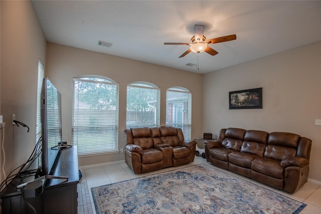 living room with light tile patterned floors, visible vents, and ceiling fan