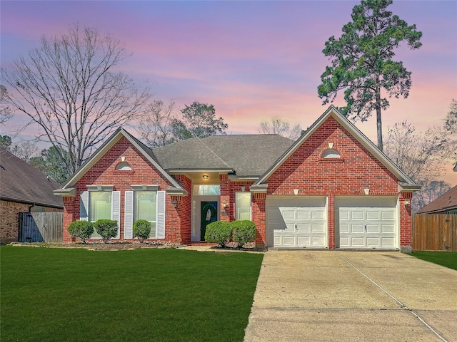 view of front of house with brick siding, a front lawn, driveway, and fence