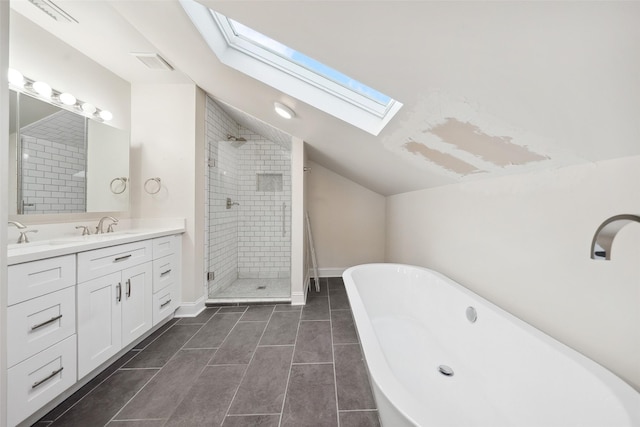 full bathroom with vanity, vaulted ceiling, a soaking tub, and a stall shower