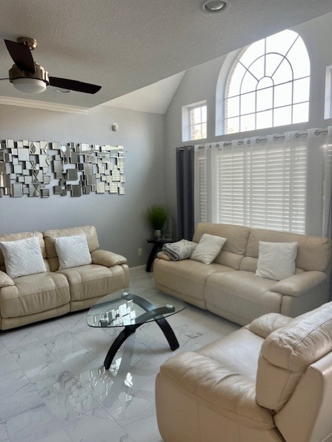 living room with vaulted ceiling, marble finish floor, a textured ceiling, and a ceiling fan