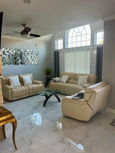 living area with lofted ceiling, a ceiling fan, baseboards, marble finish floor, and crown molding