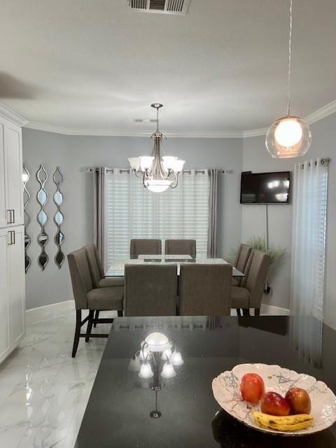 dining room featuring baseboards, visible vents, marble finish floor, crown molding, and a chandelier