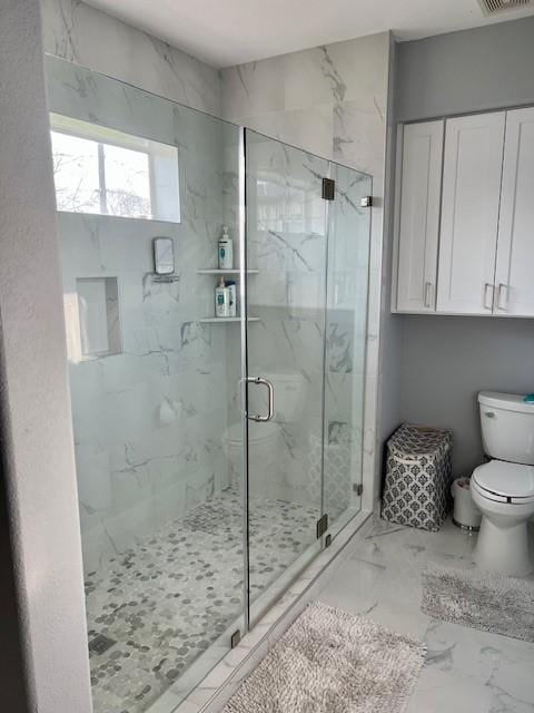 full bathroom with visible vents, marble finish floor, a marble finish shower, and toilet