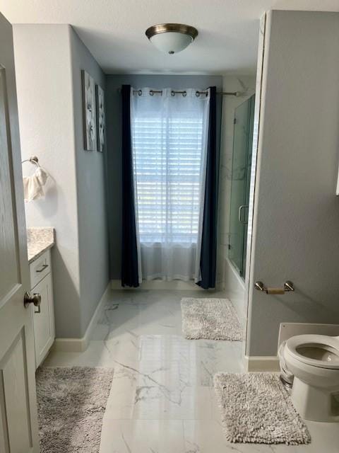 full bathroom featuring marble finish floor, shower / bath combination with glass door, toilet, vanity, and baseboards