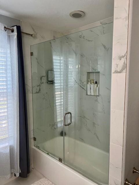 full bathroom with shower / bath combination with glass door