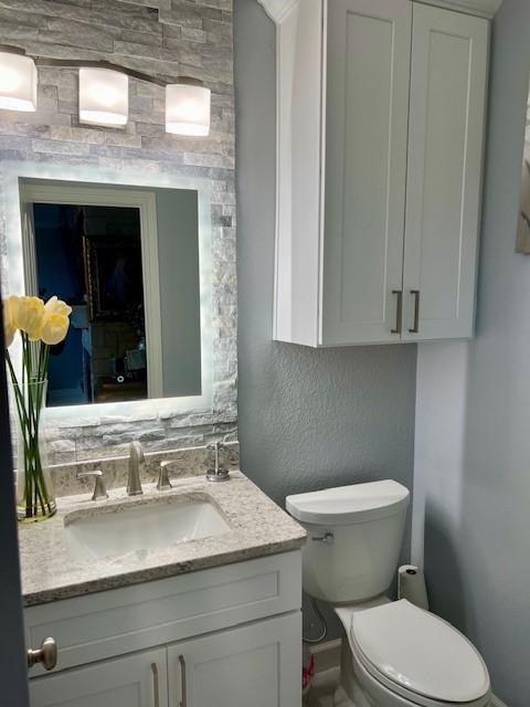 bathroom with toilet and vanity