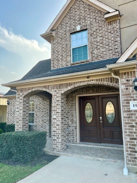 property entrance with brick siding