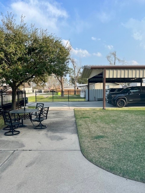 view of property's community featuring a lawn and fence