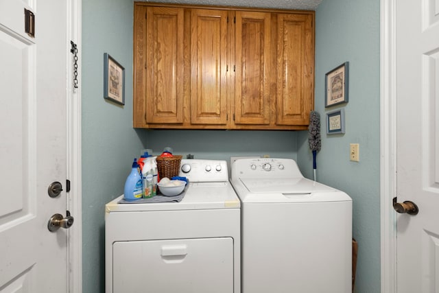 laundry area with cabinet space and washing machine and clothes dryer