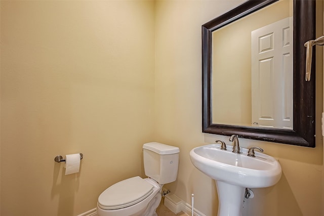 5938 Kansas St, Houston, TX 77007 - bathroom with baseboards, toilet, and a sink