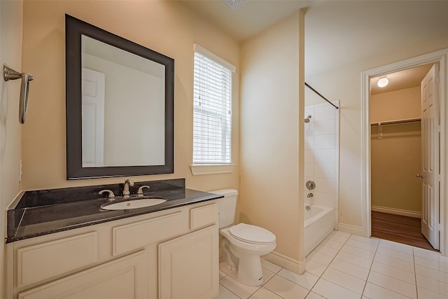 full bathroom featuring tile patterned flooring, toilet, vanity, baseboards, and shower / washtub combination