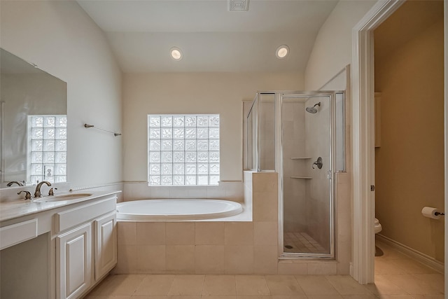 bathroom featuring tile patterned floors, a healthy amount of sunlight, a shower stall, and a bath