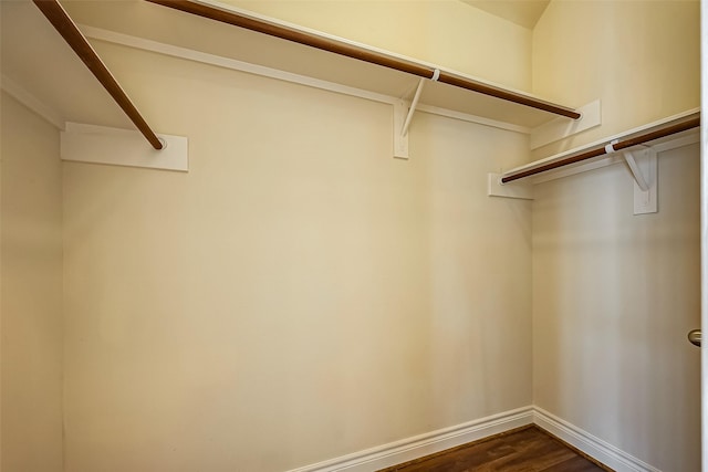 walk in closet featuring dark wood-style flooring