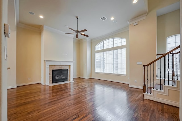 unfurnished living room with stairs, ornamental molding, wood finished floors, and visible vents