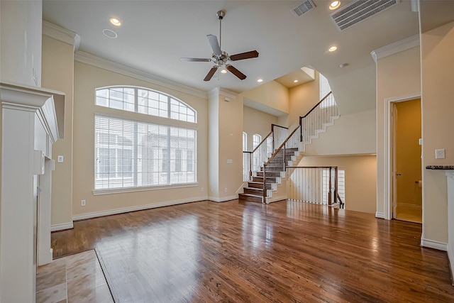 5938 Kansas St, Houston, TX 77007 - unfurnished living room with a ceiling fan, wood finished floors, ornamental molding, stairs, and baseboards