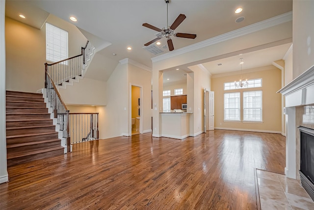 5938 Kansas St, Houston, TX 77007 - unfurnished living room featuring wood finished floors, stairs, a chandelier, a tiled fireplace, and recessed lighting