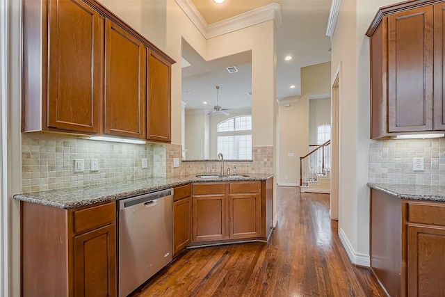 5938 Kansas St, Houston, TX 77007 - kitchen with stainless steel dishwasher, a sink, crown molding, brown cabinets, and recessed lighting