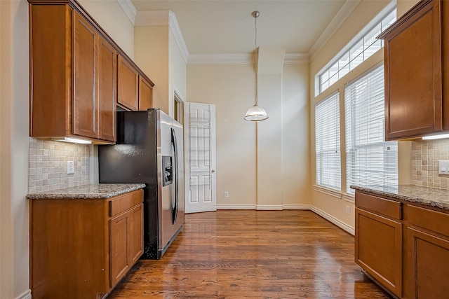 kitchen with brown cabinetry, dark wood-type flooring, crown molding, and stainless steel fridge with ice dispenser