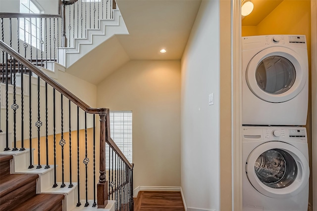 washroom with baseboards, laundry area, stacked washer and clothes dryer, and recessed lighting