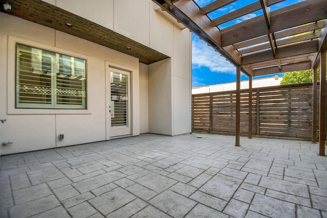 view of patio / terrace with a pergola and fence